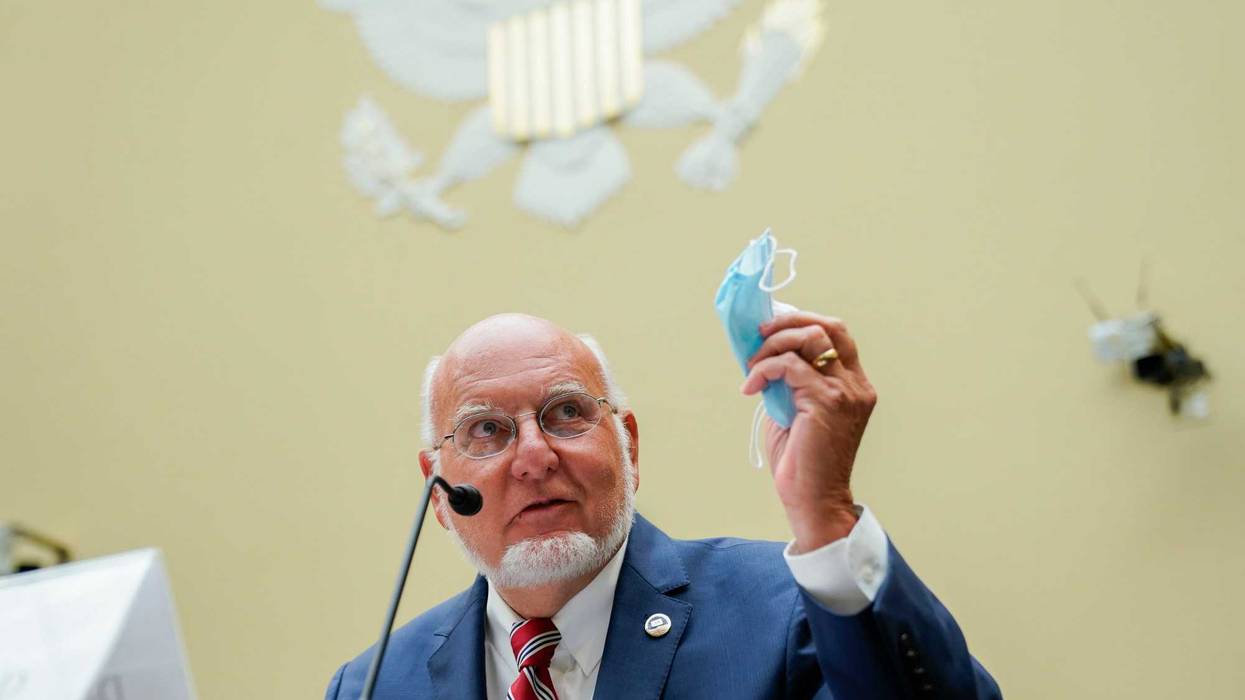 Robert Redfield, director of the Centers for Disease Control and Prevention (CDC) holds a protective mask while testifying during a House Select Subcommittee on the Coronavirus Crisis hearing on July 31, 2020 in Washington, DC.