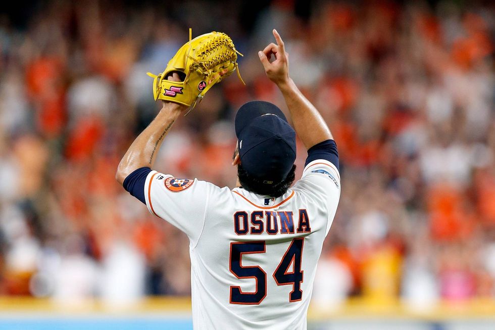 Roberto Osuna points to the sky after an Astros victory at Minute Maid Park