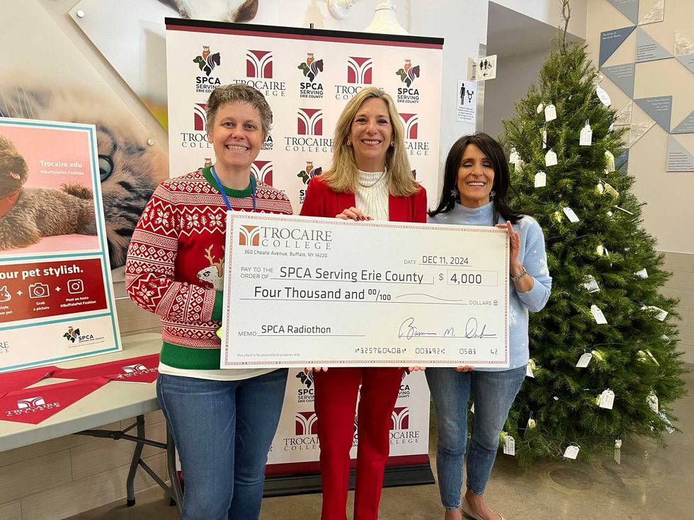 Robin Wolfgang of Trocaire College presenting a $4K check to the SPCA Serving Erie County