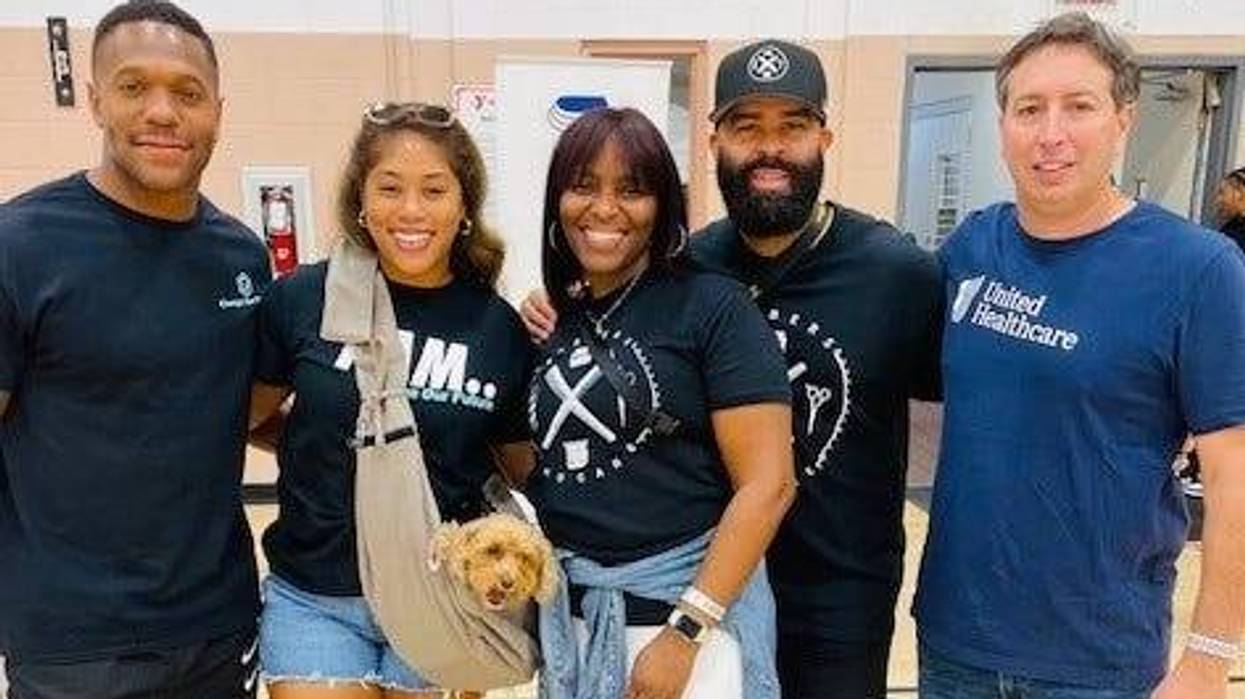 Rodney and Erica McLeod (left) and Barbers Who Care co-founder Kenny Duncan (second from right) at the 14th Annual Barbers Who Care Back-to-School Giveback