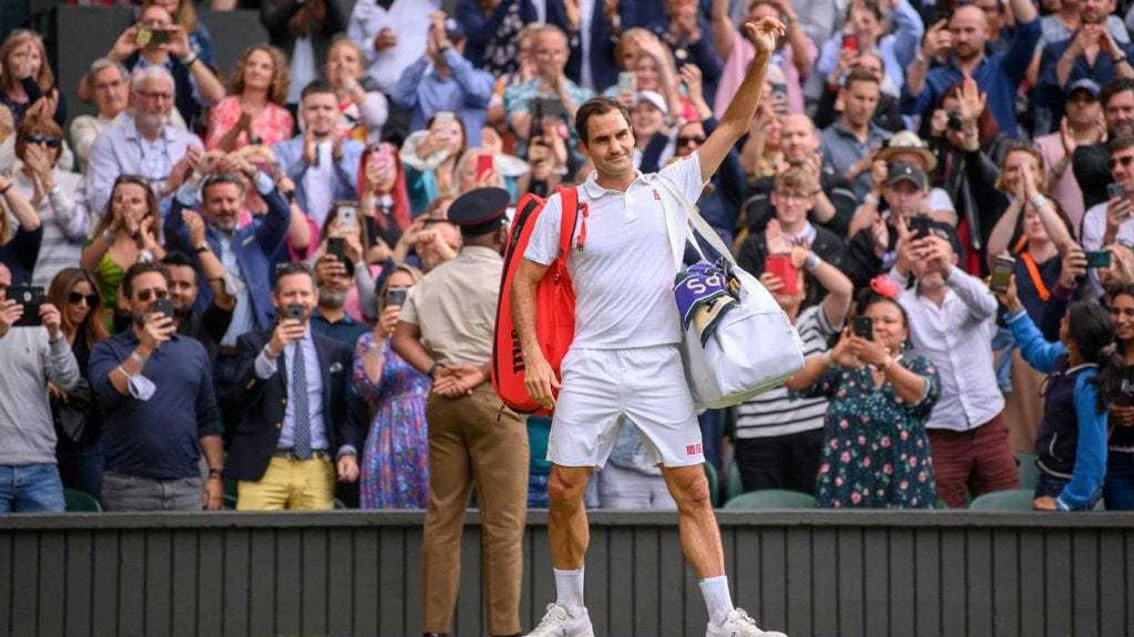 Roger Federer of Switzerland waves to the crowd after losing his men's Singles Quarter Final match against Hubert Hurkacz of Poland on Day Nine of The Championships - Wimbledon 2021 at All England Lawn Tennis and Croquet Club on July 07, 2021 in London, England.