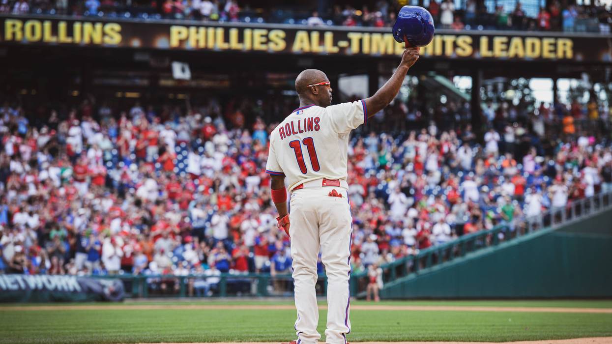 Rollins tips his helmet to fans during his final Phillies season in 2014 after becoming the team's all-time hit leader.