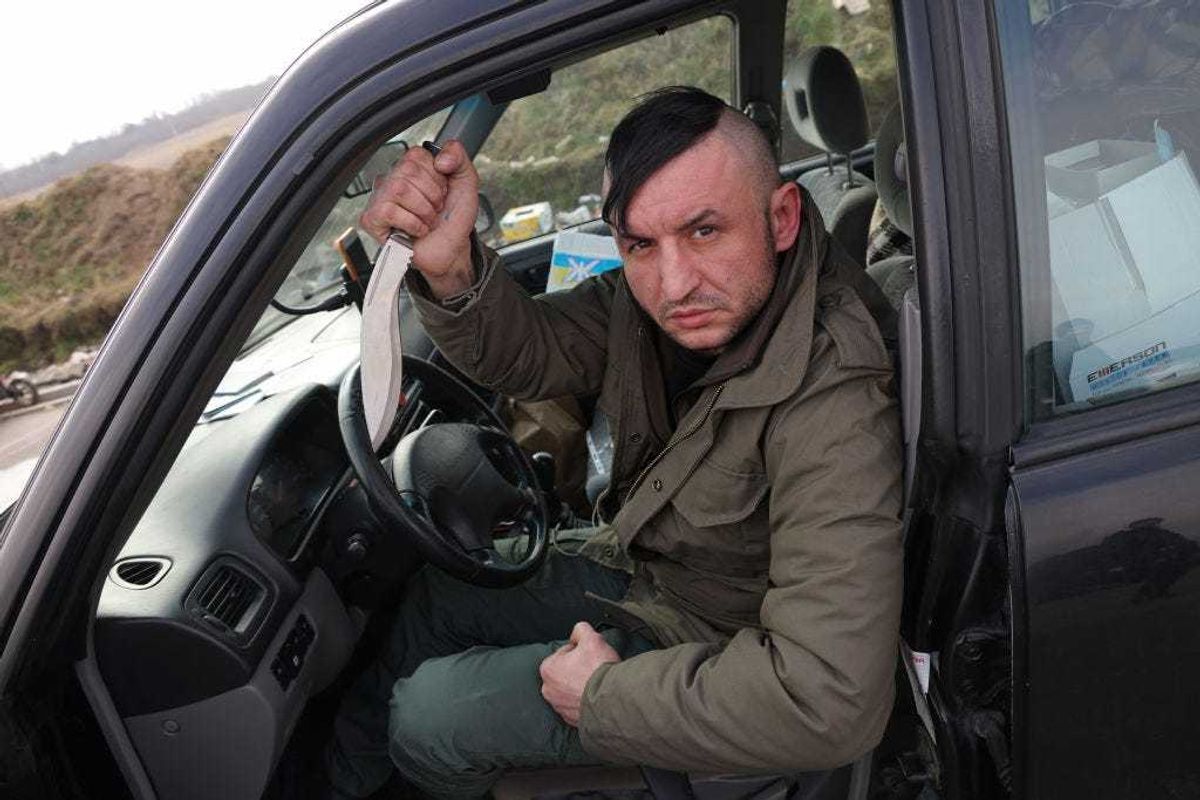 Roman, 35, a Ukrainian living in Poland, displays his knife as he waits to cross into Ukraine to join the armed resistance against the Russian invasion at the Medyka border crossing on March 04, 2022 in Medyka, Poland. In a report issued by the Ukrainian army stating the creation of a foreign legion unit for international volunteers, Ukraine's President Zelensky appealed to foreign nationals to join his army in the fight against Russia. On February 24, 2022 Russia began a large-scale attack on Ukraine, besieging its major cities. (Photo by Sean Gallup/Getty Images)