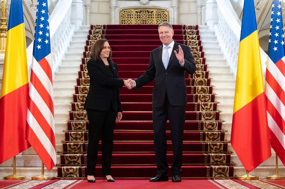 Romanian President Klaus Iohannis shakes hands with US Vice President Kamala Harris as she arrives for meetings at Cotroceni Palace in Otopeni, Romania, Friday, March 11, 2022