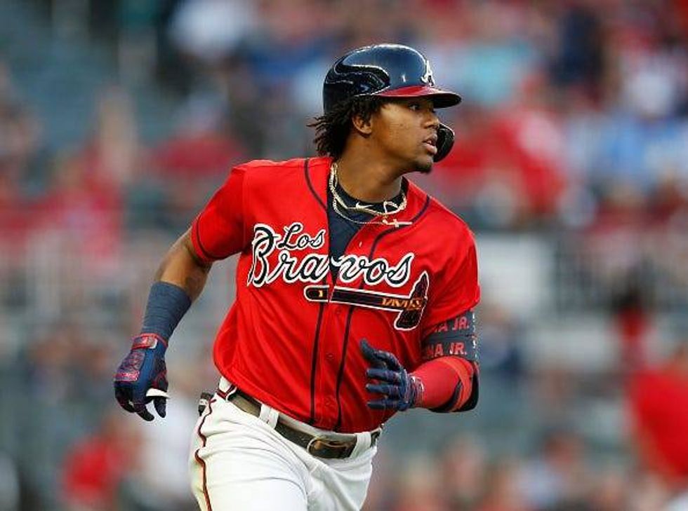 Ronald Acuna runs to first base.