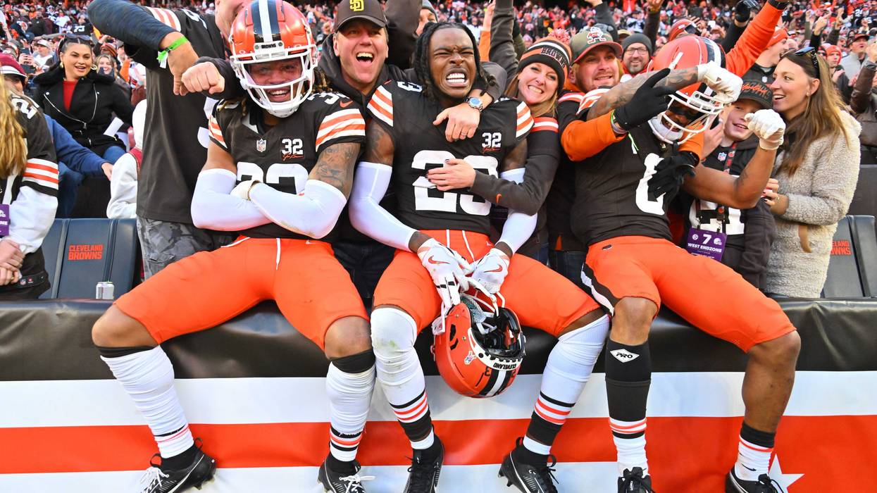 Ronnie Hickman #33, Martin Emerson Jr. #23, and Greg Newsome II #0 of the Cleveland Browns celebrate with fans after beating the Pittsburgh Steelers 13-10 at Cleveland Browns Stadium on November 19, 2023 in Cleveland, Ohio.