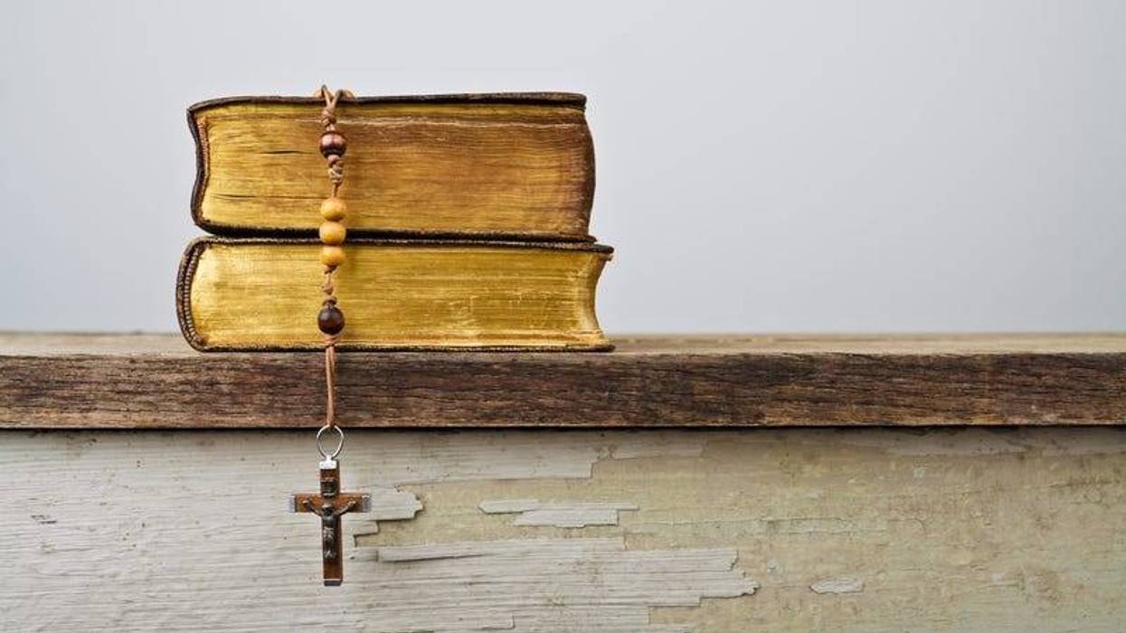 Rosary beads and books of Catholic Church liturgy