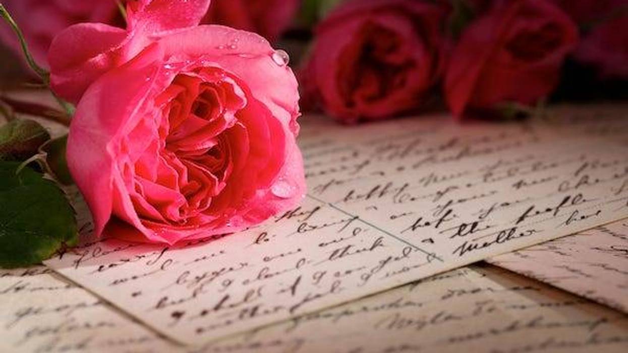 Roses on top of handwritten letters and postcard