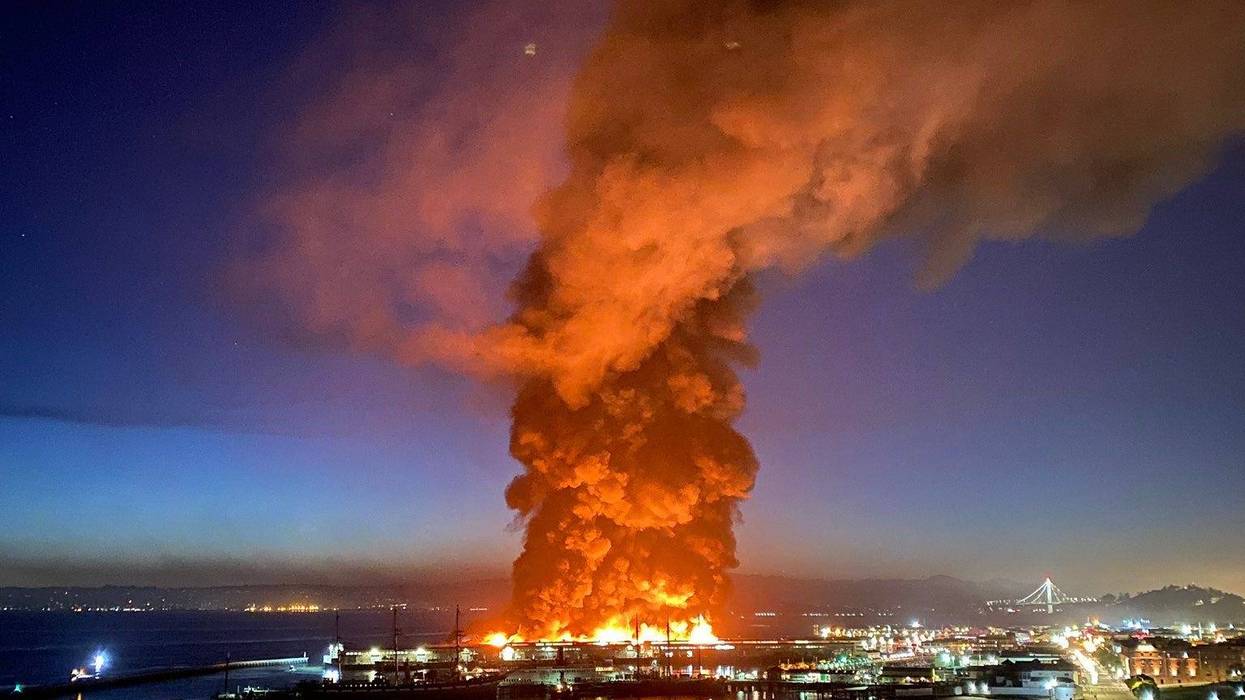 Roughly 100 firefighters are battling a four-alarm fire at a warehouse building at Fisherman's Wharf in San Francisco.