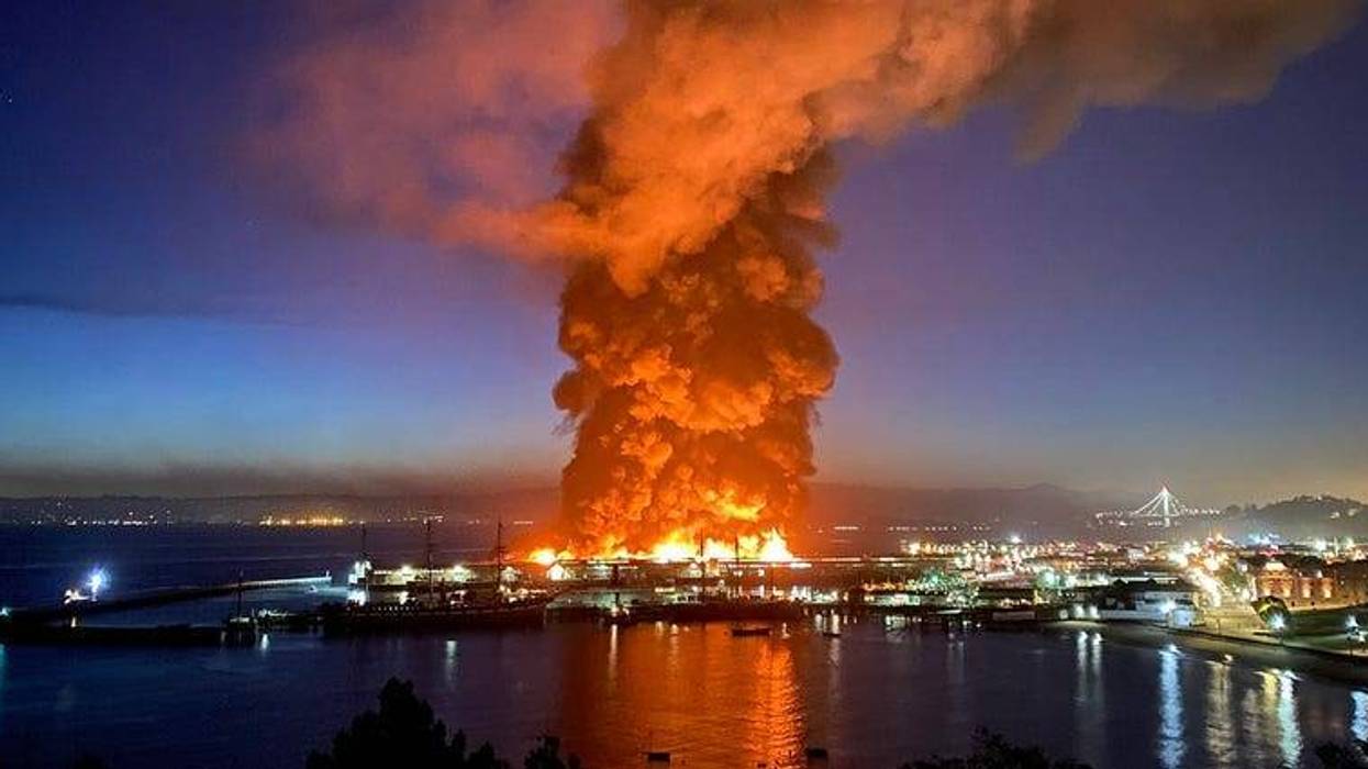 Roughly 100 firefighters are battling a four-alarm fire at a warehouse building at Fisherman's Wharf in San Francisco.