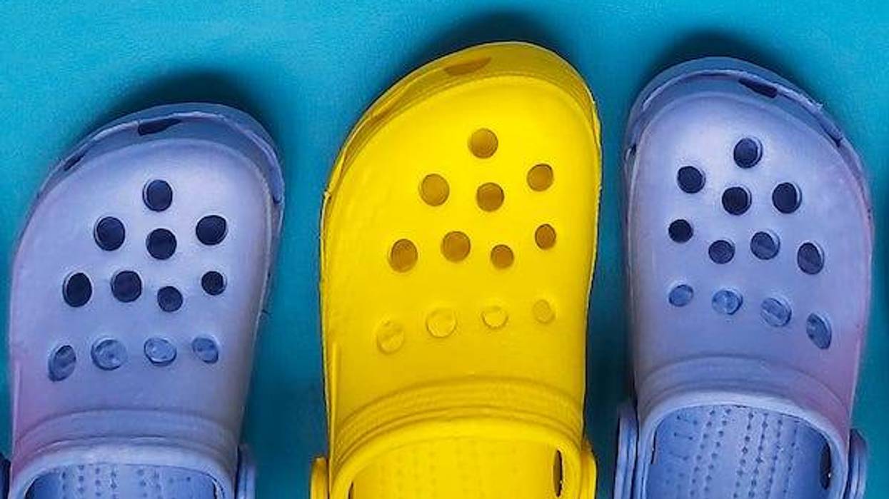 Row of Crocs against blue background
