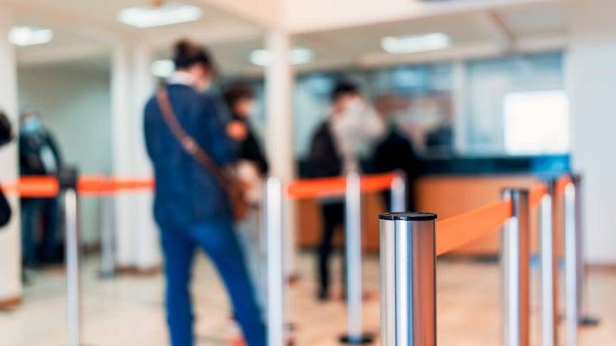 Row of people waiting in line at a bank