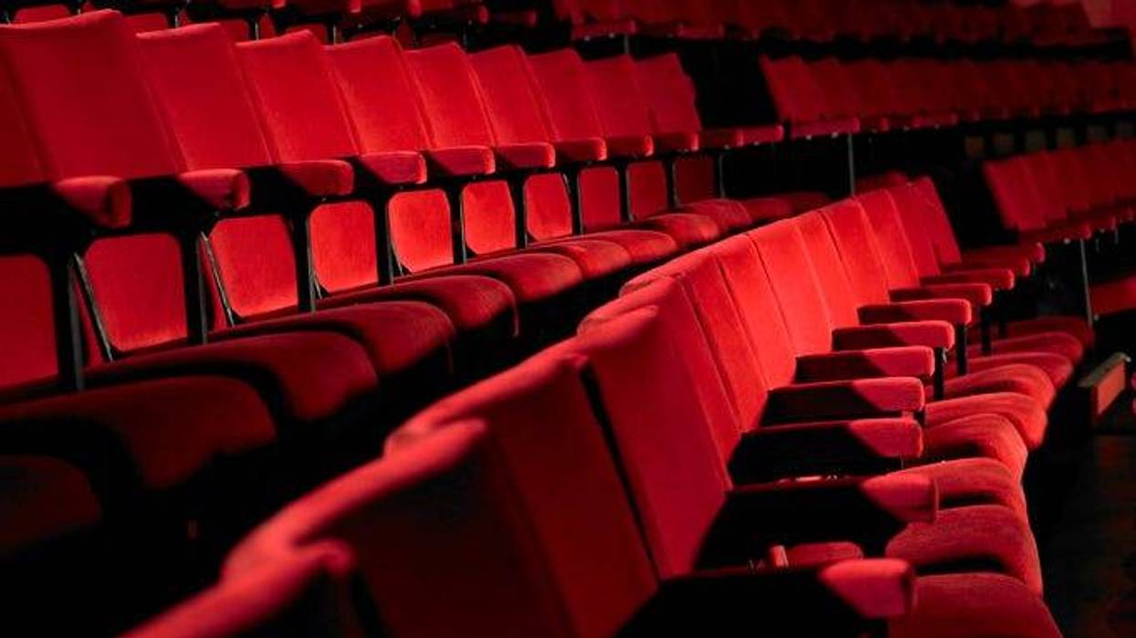 Rows of empty red cinema seats