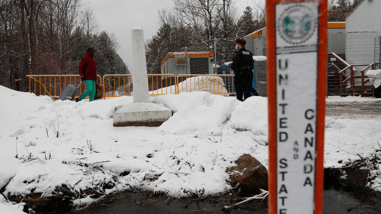 Royal Canadian Mounted Police officers are seen at the Roxham Road border crossing in Champlain, New York