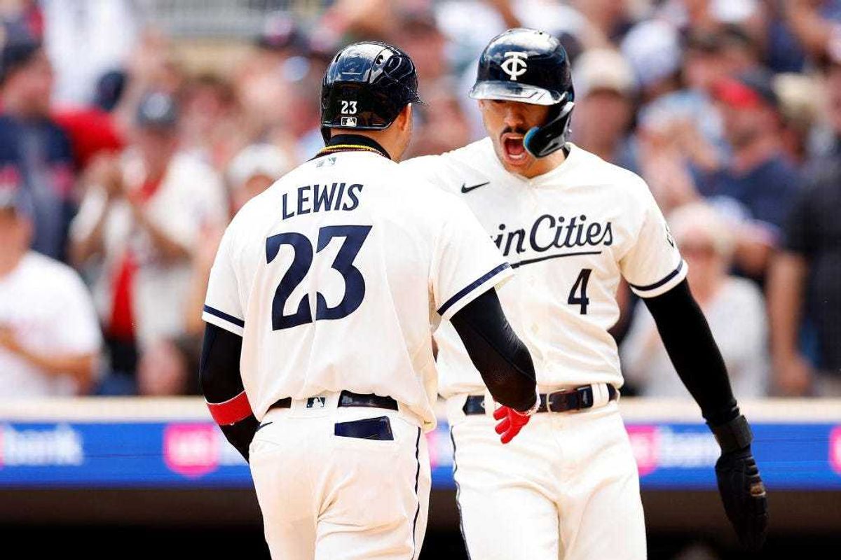 Royce Lewis #23 of the Minnesota Twins celebrates his grand slam against the Texas Rangers with teammate Carlos Correa #4 in the sixth inning at Target Field on August 27, 2023 in Minneapolis, Minnesota. The Twins defeated the Rangers 7-6 in 13 innings.
