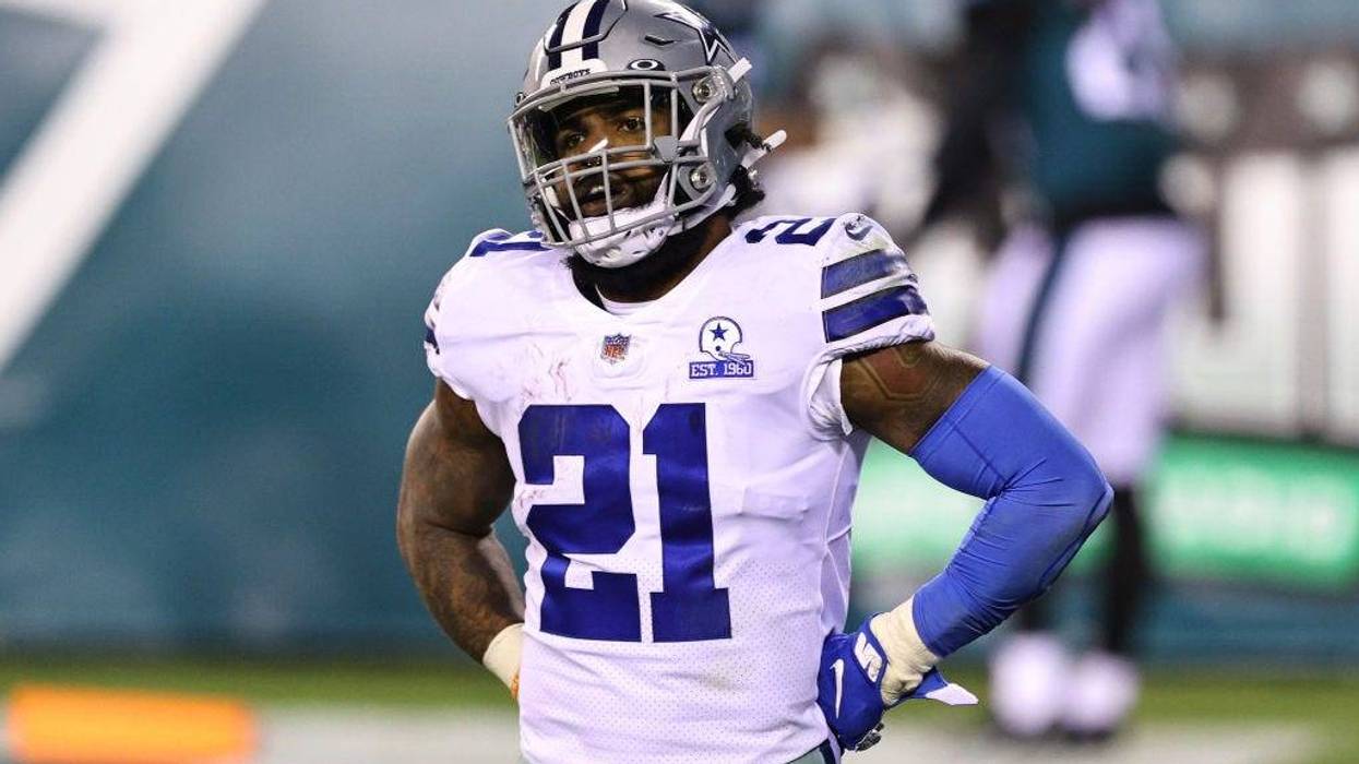 Running back Ezekiel Elliott #21 of the Dallas Cowboys looks on as Rodney McLeod #23 of the Philadelphia Eagles celebrates with Avonte Maddox #29 in the background.
