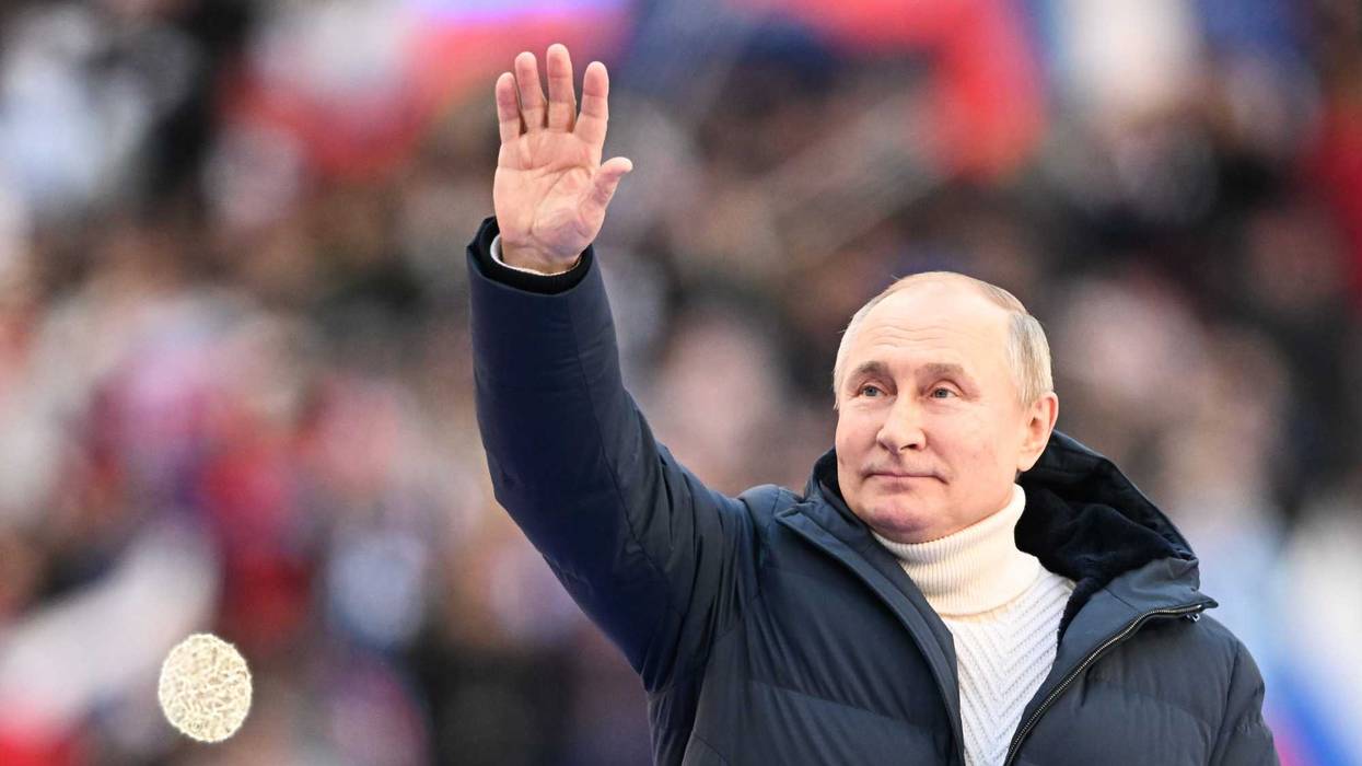 Russia's President Vladimir Putin attends a concert titled Crimean Spring held at Luzhniki Stadium to mark the 8th anniversary of the reunification of Crimea with Russia