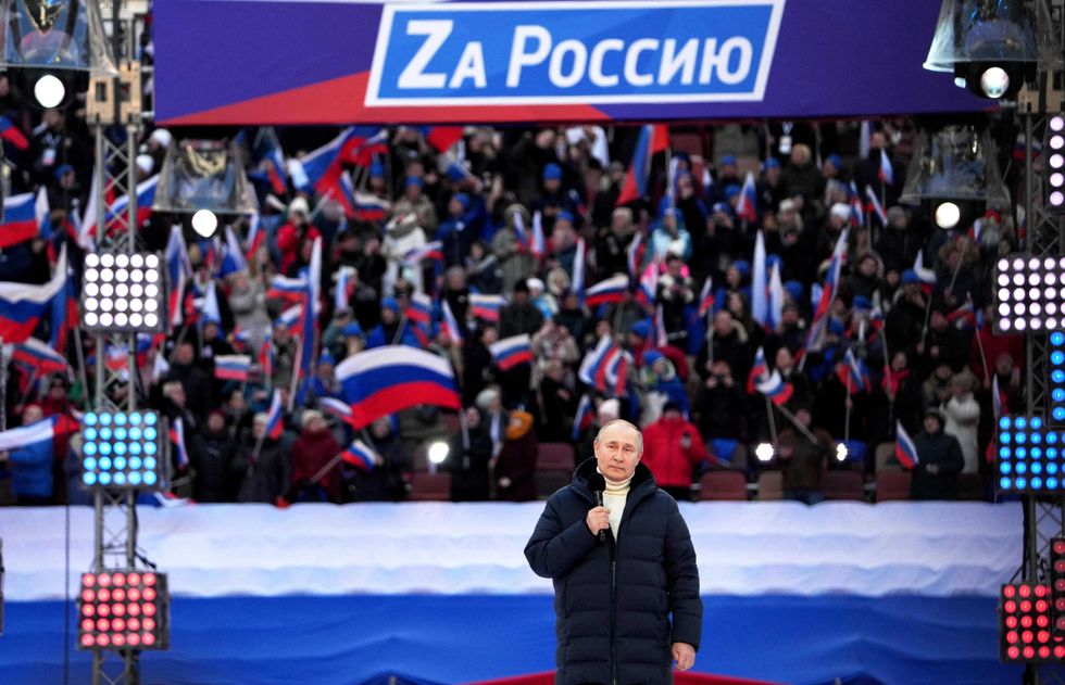 Russian President Vladimir Putin gives a speech during a concert marking the eighth anniversary of Russia