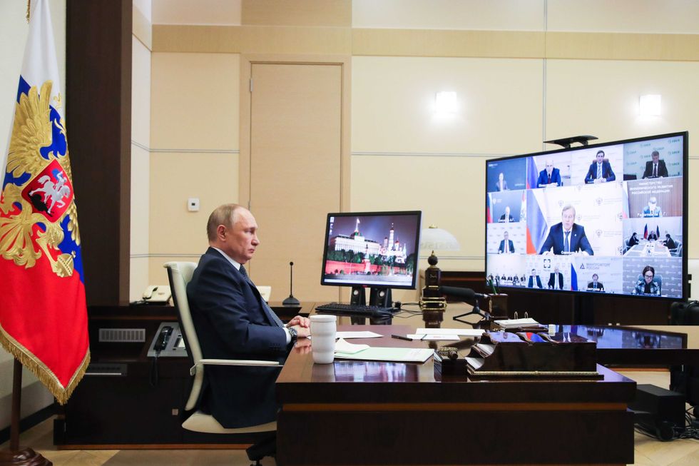 Russian President Vladimir Putin is seen in his office in the Novo-Ogaryovo residence during a videoconference meeting of Russian government officials to discuss the development of the air transport and aircraft industry in Russia on March 31, 2022