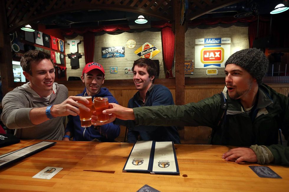 Russian River Brewing Company customers toast their glasses before drinking the newly released Pliny the Younger triple IPA beer on February 7, 2014 in Santa Rosa, California.