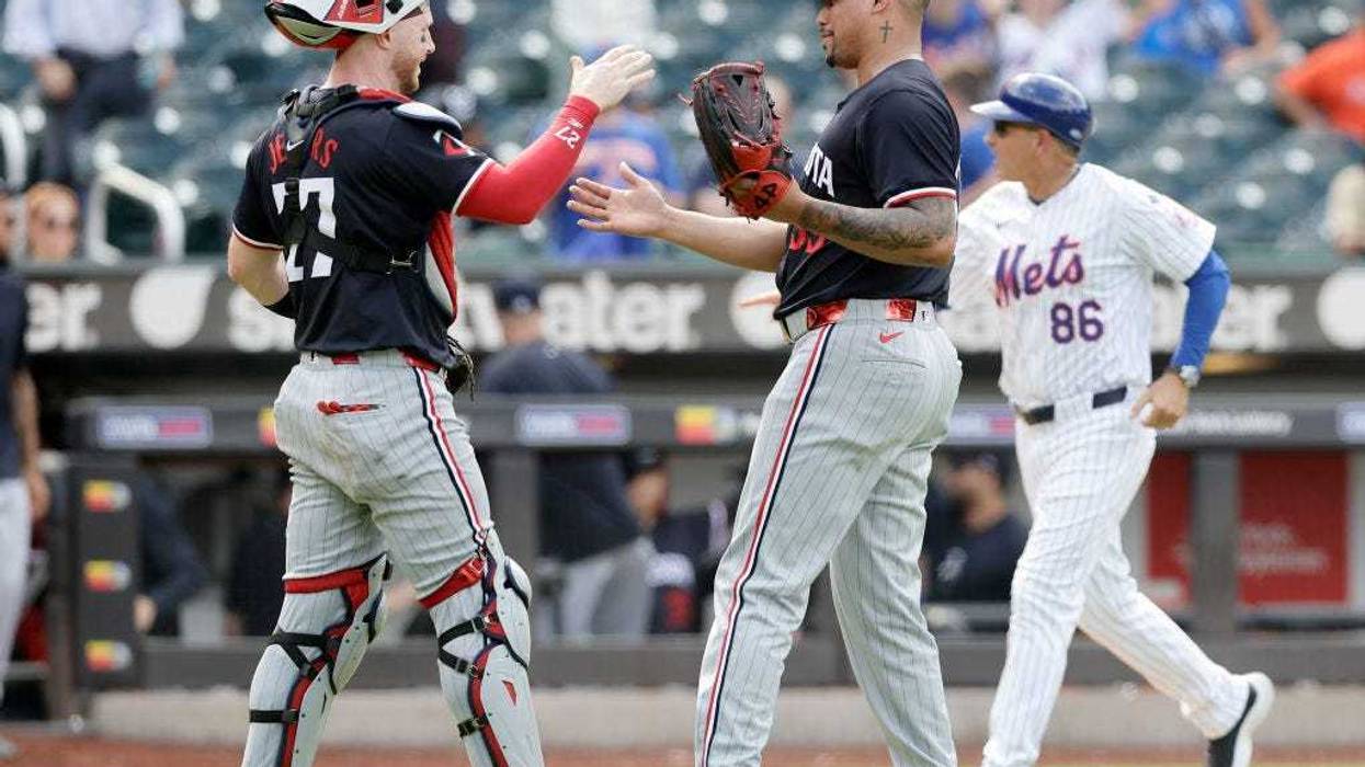 Ryan Jeffers #27 and Jhoan Duran #59 of the Minnesota Twins celebrate after defeating the New York Mets at Citi Field on July 31, 2024 in New York City.