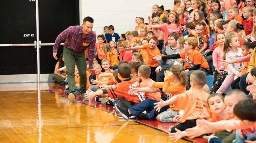 Ryan Leckey with kids in a gym