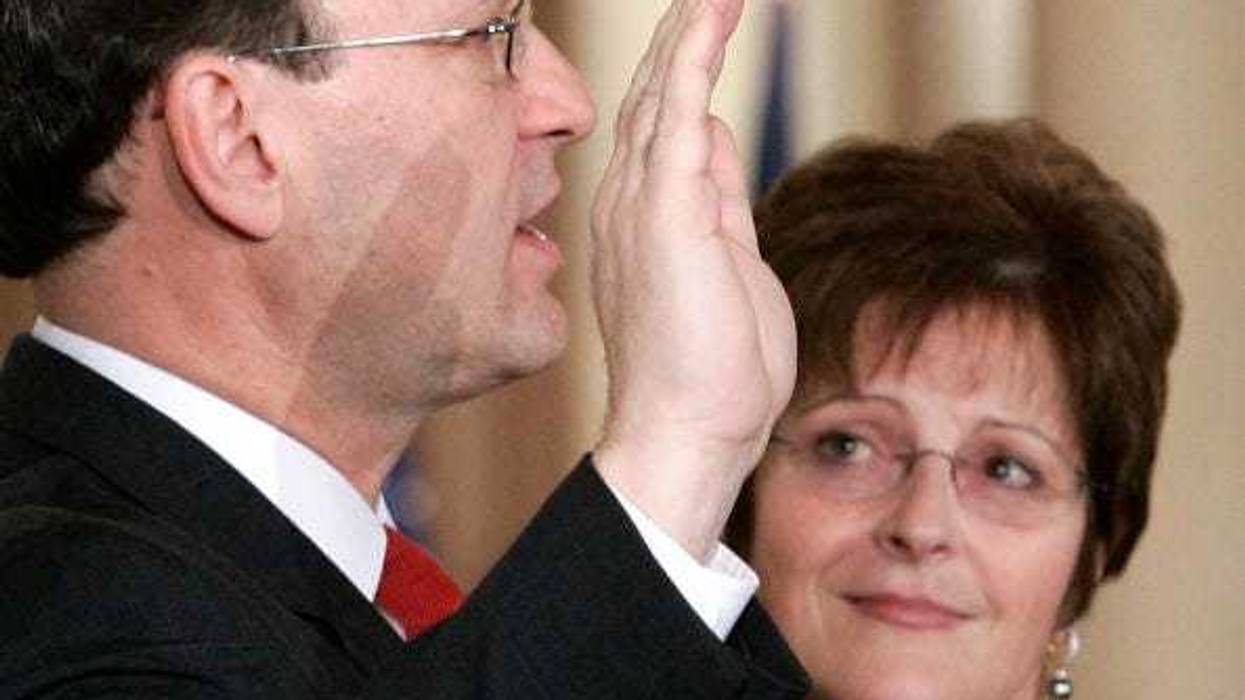 .S. Supreme Court Justice Samuel Alito (L) is sworn in as his wife Martha-Ann Bomgardner looks on during a ceremonial swearing-in at the East Room of the White House February 1, 2006 in Washington, DC.