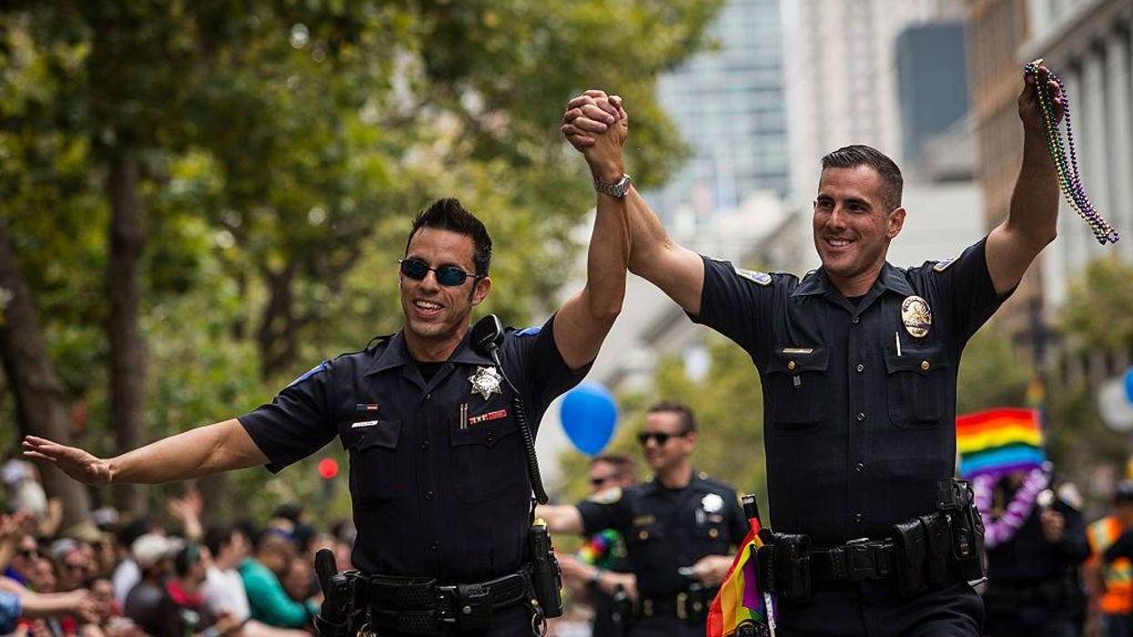 Sacramento Police Officer Jeff Kuhlmann, left, marches with his boyfriend, Los Angeles Police Officer David Ayala, right, in the San Francisco Gay Pride Parade, June 28, 2015 in San Francisco, California.