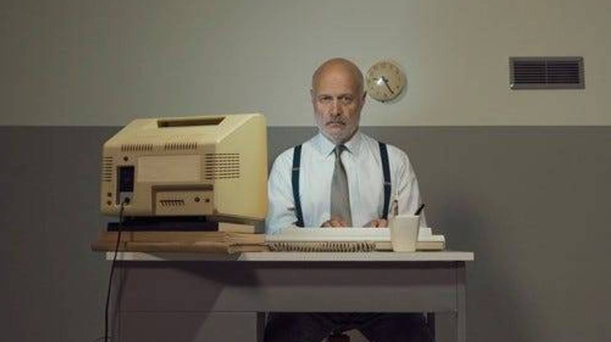 sad man with very old computer