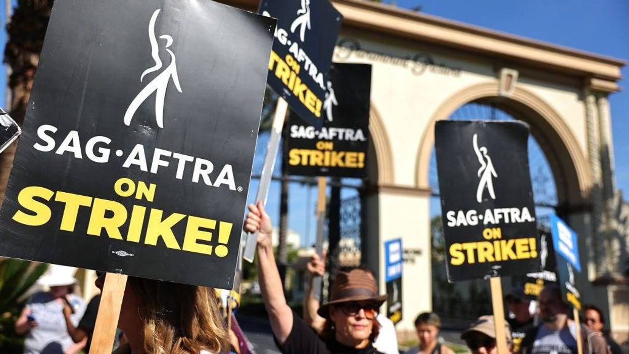 SAG-AFTRA member Caryn West (C) and other members and supporters picket outside Paramount Studios on day 113 of their strike against the Hollywood studios on November 3, 2023 in Los Angeles, California.