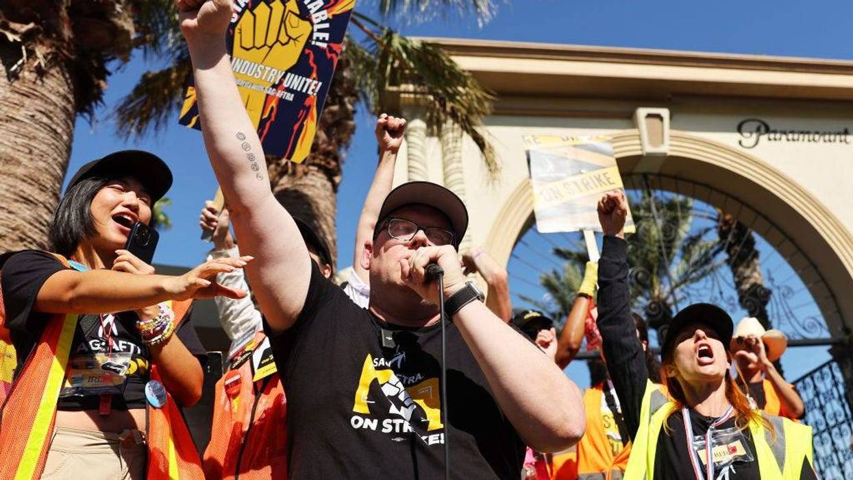 SAG-AFTRA National Executive Director and chief negotiator Duncan Crabtree-Ireland (C) raises his fist while speaking at the conclusion of picketing outside Paramount Studios on day 113 of their strike against the Hollywood studios on November 3, 2023 in Los Angeles, California.