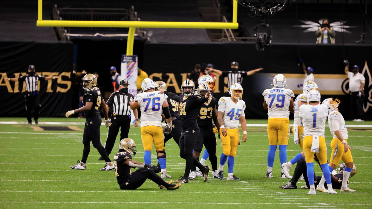 Saints players look on as Chargers kicker Michael Badgley misses a field goal