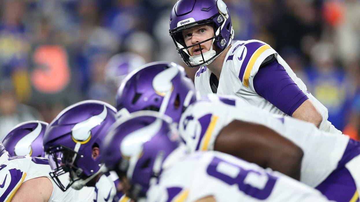 Sam Darnold #14 of the Minnesota Vikings prepares to snap the ball during the third quarter against the Los Angeles Rams during the NFC Wild Card Playoff at State Farm Stadium on January 13, 2025 in Glendale, Arizona.