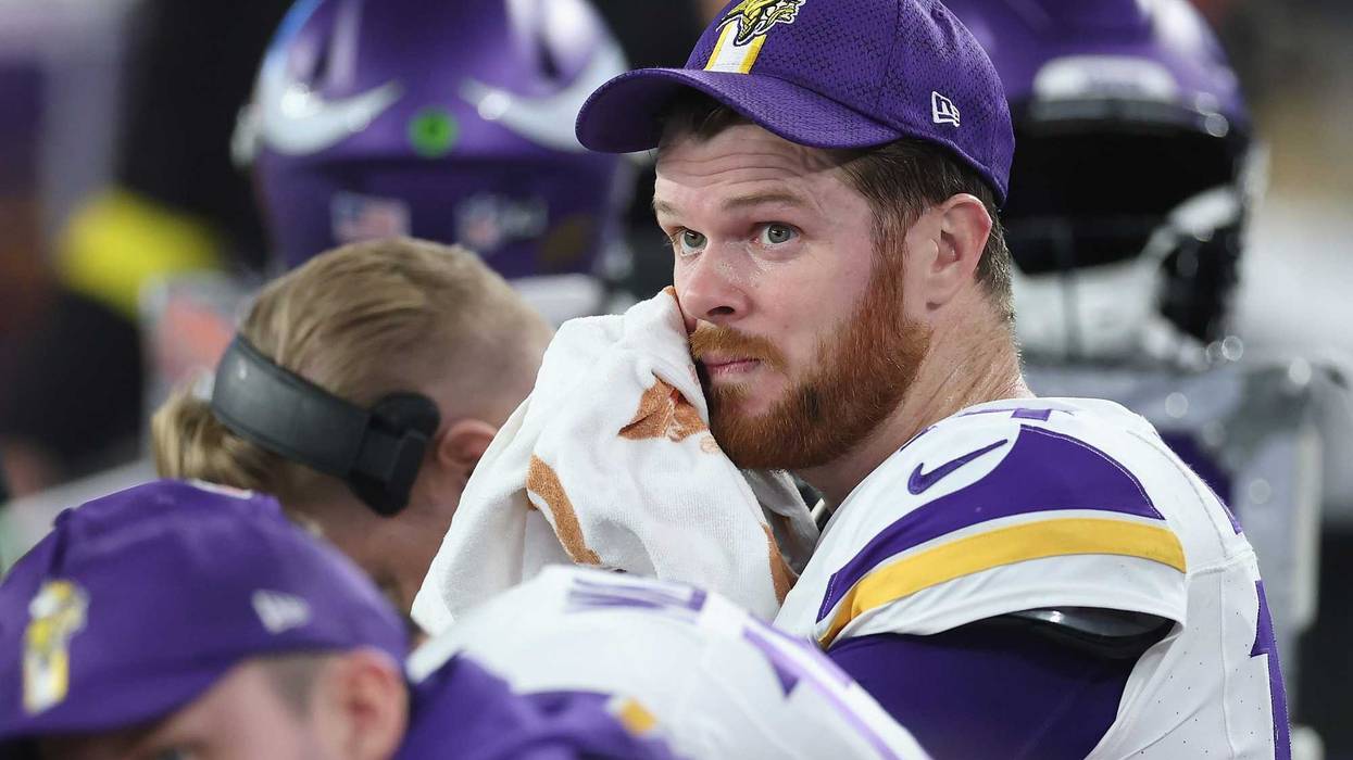 Sam Darnold #14 of the Minnesota Vikings reacts on the bench during the NFL playoff game at State Farm Stadium on January 13, 2025 in Glendale, Arizona. The Rams defeated the Vikings 27-9