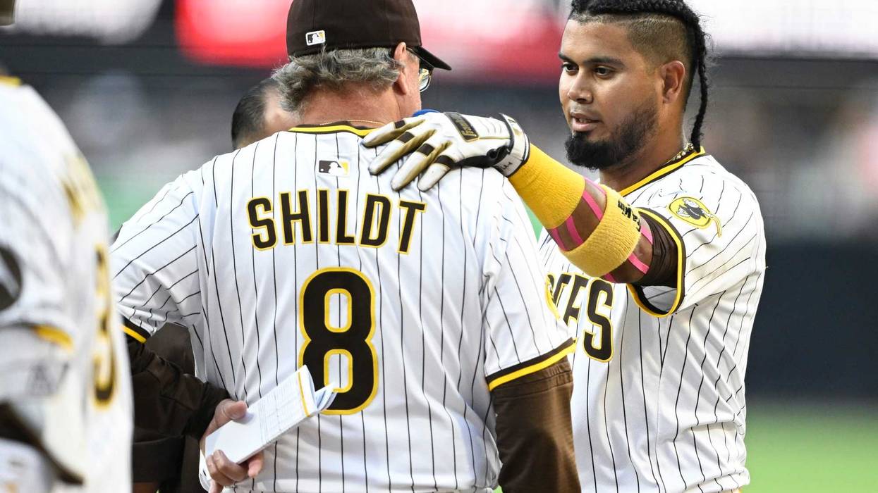 San Diego Padres first baseman Luis Arraez (4) talks with manager Mike Shildt (8) after fouling a ball off during the first inning against the Arizona Diamondbacks at Petco Park