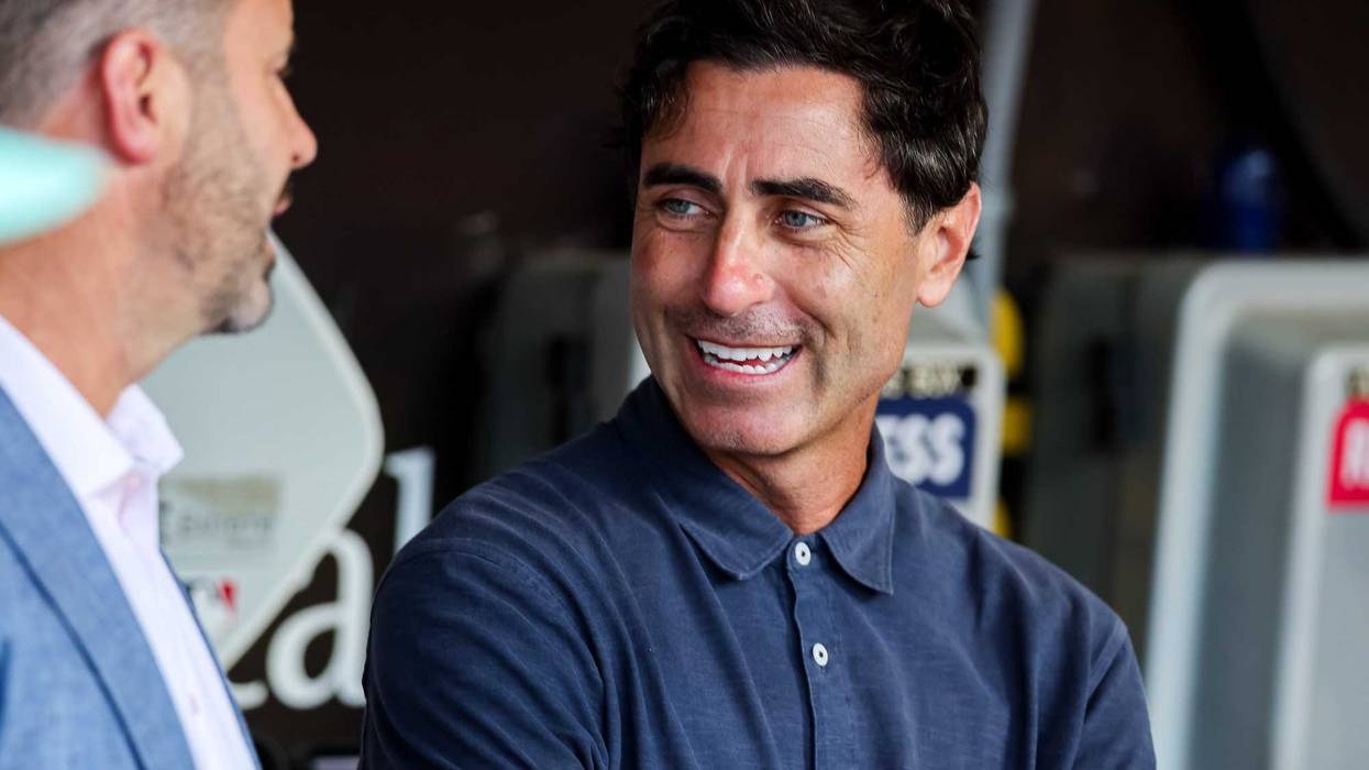 San Diego Padres general manager AJ Preller, right, talks with CEO Erik Greupner in the dugout before the game against the St. Louis Cardinals at Petco Park
