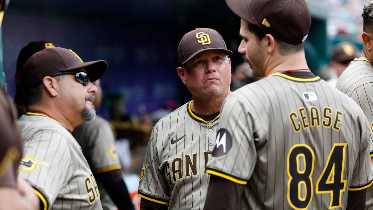 San Diego Padres pitcher Dylan Cease (84) talks with Padres pitching coach Ruben Niebla (57) and Padres manager Mike Shildt (8) in the dugout at the end of the seventh inning against the Washington Nationals at Nationals Park