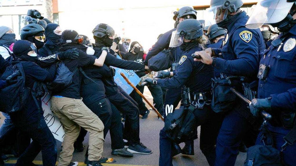 San Diego police clash with protesters after a gathering was declared an unlawful assembly, Saturday, Jan. 9, 2021, in San Diego.