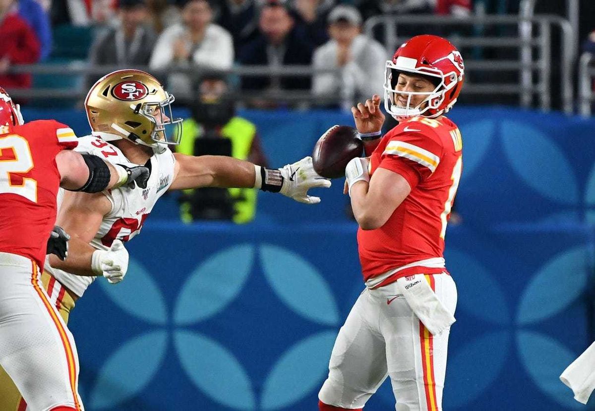 San Francisco 49ers defensive end Nick Bosa (97) knocks the ball out of Kansas City Chiefs quarterback Patrick Mahomes (15) hands during the third quarter in Super Bowl LIV at Hard Rock Stadium.