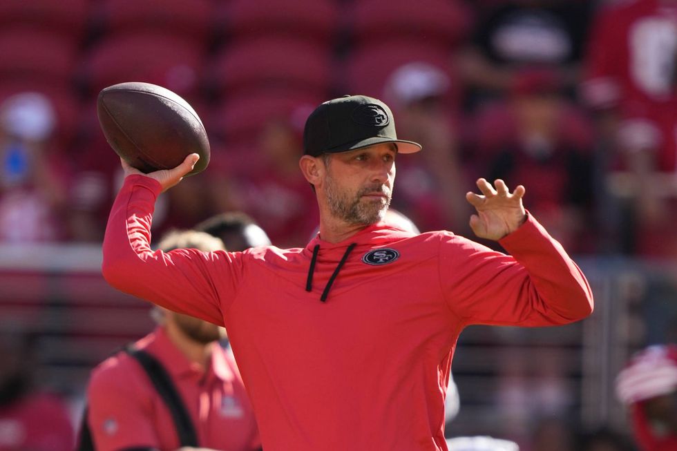 San Francisco 49ers head coach Kyle Shanahan throws the football before the game against the Green Bay Packers at Levi
