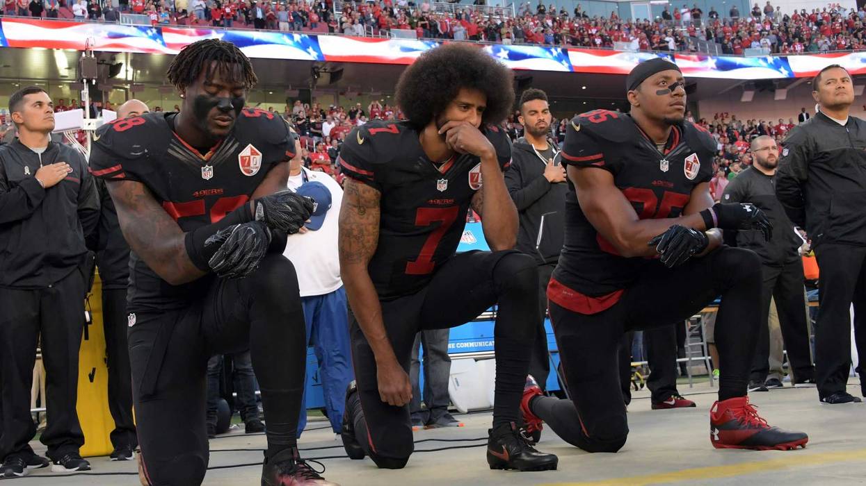 San Francisco 49ers outside linebacker Eli Harold (58), quarterback Colin Kaepernick (7) and free safety Eric Reid (35) kneel in protest during the playing of the national anthem before a NFL game