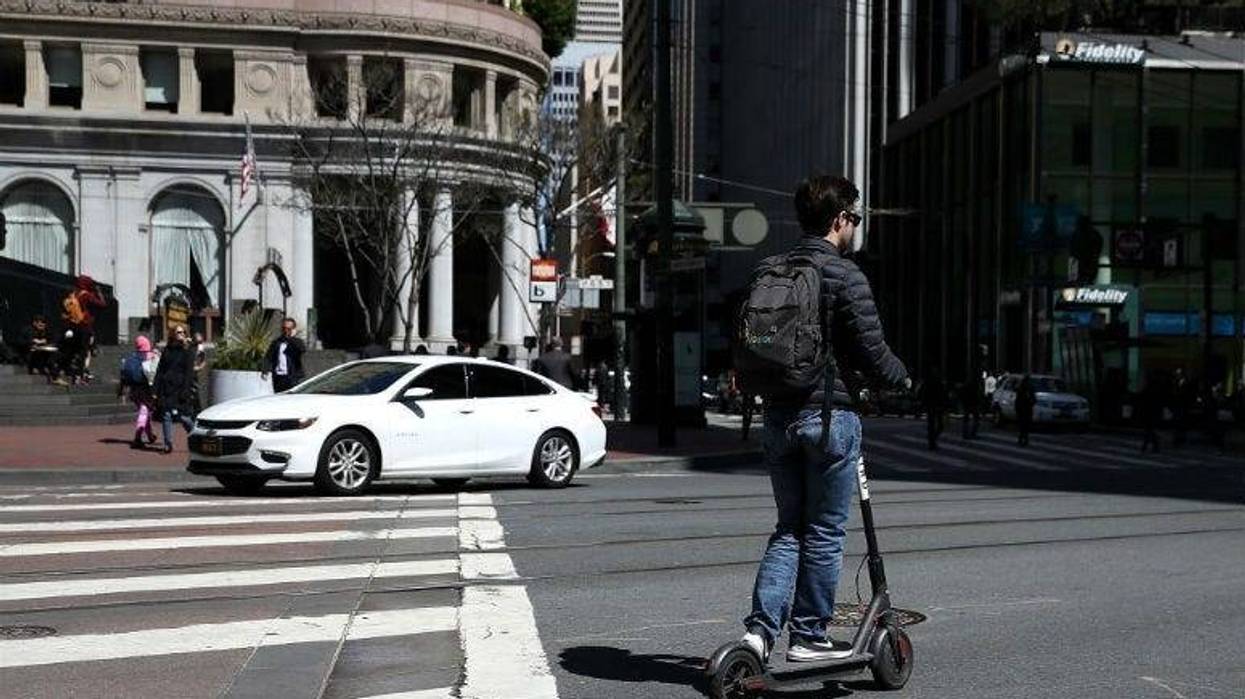 SAN FRANCISCO, CA - APRIL 17: A user rides a Bird scooter on April 17, 2018 in San Francisco, California.