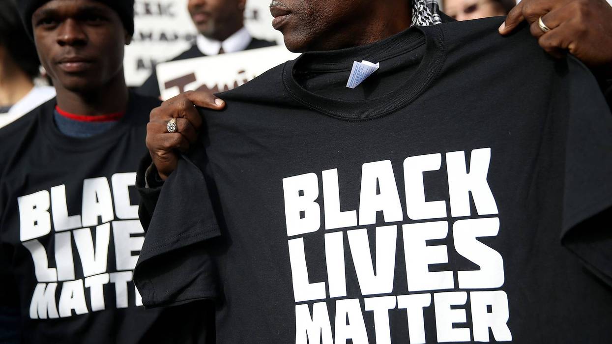 SAN FRANCISCO, CA - DECEMBER 18: A protester holds a black lives matter t-shirt during a "Hands Up, Don't Shoot" demonstration in front of the San Francisco Hall of Justice on December 18, 2014 in San Francisco, California.