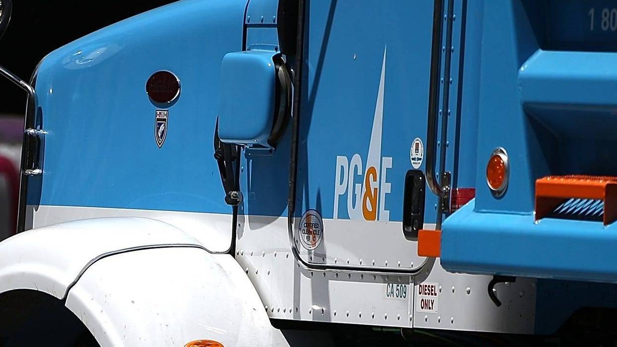 SAN FRANCISCO, CA - JULY 30: Pedestrians walk by a Pacific Gas and Electric (PG&E) truck at a job site on July 30, 2014 in San Francisco, California. A federal grand jury has added 27 new charges, including obstruction of justice, the criminal case agains