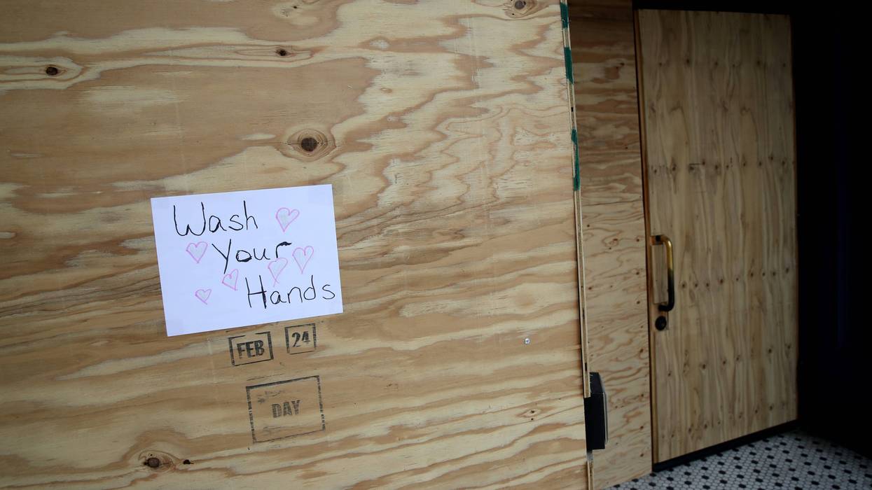 SAN FRANCISCO, CALIFORNIA - MARCH 20: A sign urging people to wash their hands is posted on plywood that is covering the windows of a business on Valencia Street on March 20, 2020 in San Francisco, California.