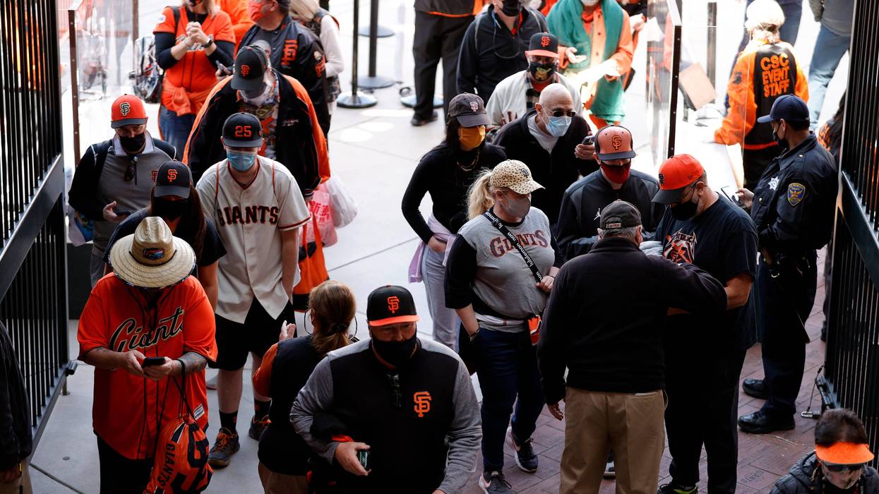 San Francisco Giants fans enter the stadium for the Giants home opener against the Colorado Rockies at Oracle Park on April 09, 2021 in San Francisco, California.