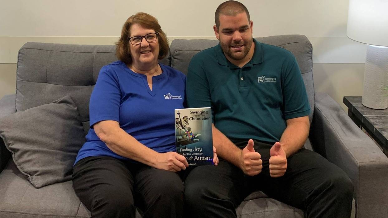 Sandy Hartranft and her son Ben Hartranft pose with Carol's new book, "Swinging from the Chandelier: Finding Joy in the Journey Through Autism".