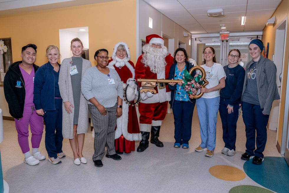 Santa, Mrs. Claus with nurses in scrubs