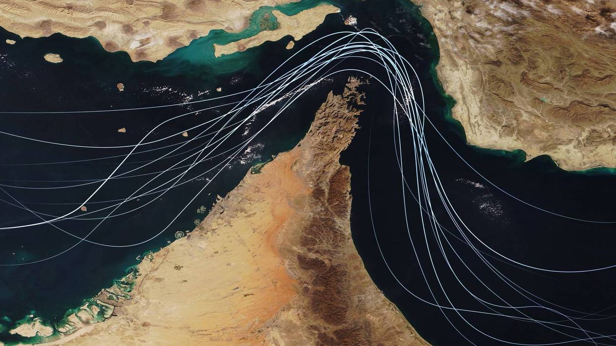 Satellite view of the Strait of Hormuz with white graphic lines representing global shipping lanes and maritime traffic between the Persian Gulf and Gulf of Oman. Strategic oil transport concept