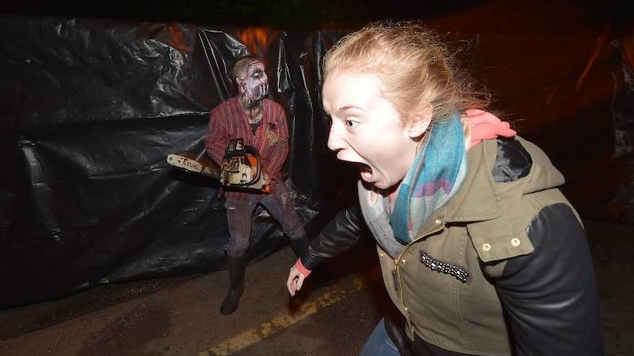 Scared woman walking through haunted house